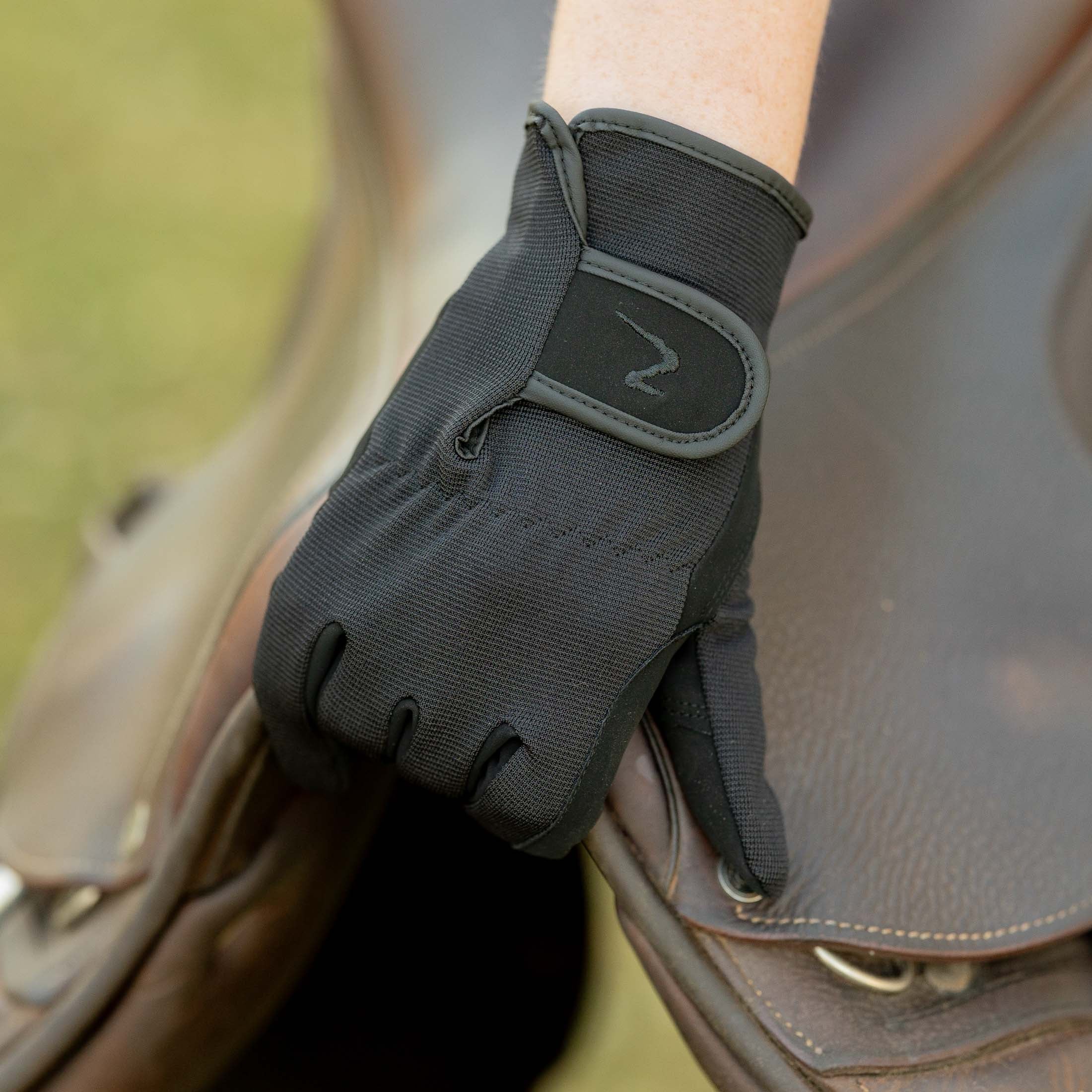 Close up of rider's gloves on horse